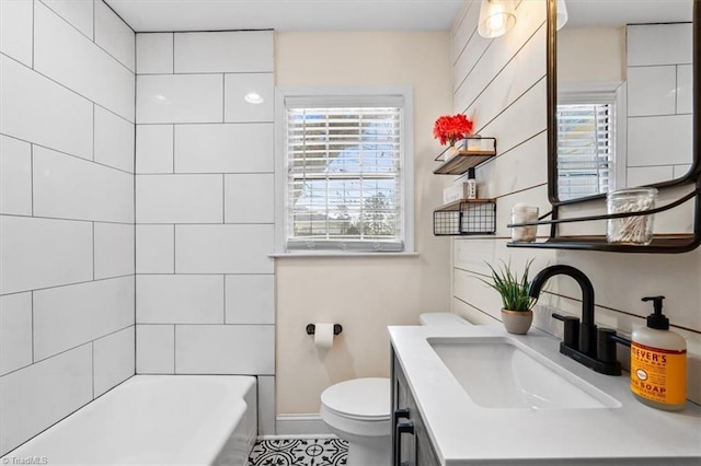 bathroom featuring plenty of natural light, toilet, and vanity