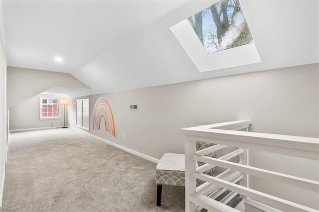 bonus room with carpet and vaulted ceiling with skylight