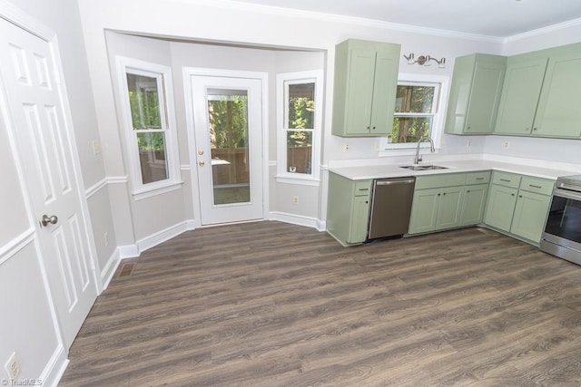 kitchen with a sink, light countertops, dark wood-style floors, green cabinetry, and stainless steel appliances