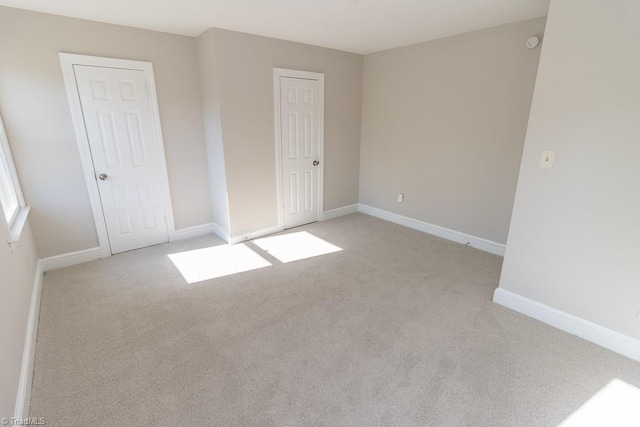 unfurnished bedroom featuring baseboards and carpet flooring