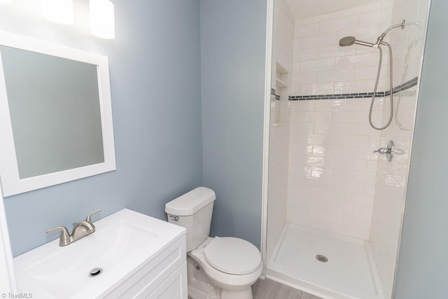 bathroom with vanity, toilet, and a stall shower