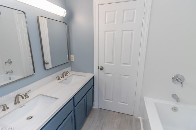 bathroom with a sink, bathtub / shower combination, and double vanity
