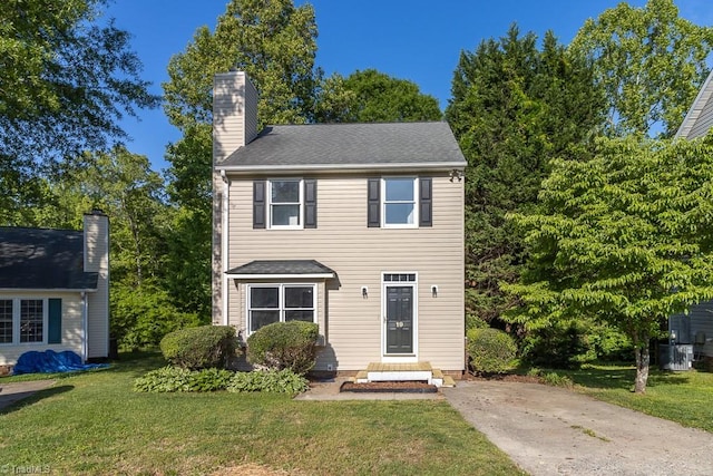 view of front of home with a chimney and a front yard