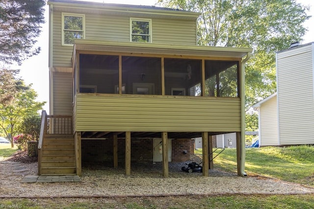 rear view of house featuring a sunroom