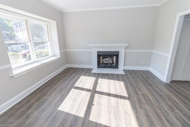 unfurnished living room featuring dark wood-style flooring, baseboards, a fireplace with flush hearth, and ornamental molding