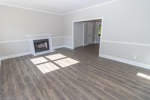 unfurnished living room with baseboards, ornamental molding, dark wood-style floors, and a fireplace