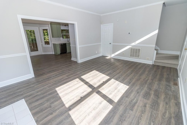unfurnished living room with baseboards, ornamental molding, dark wood-type flooring, and visible vents