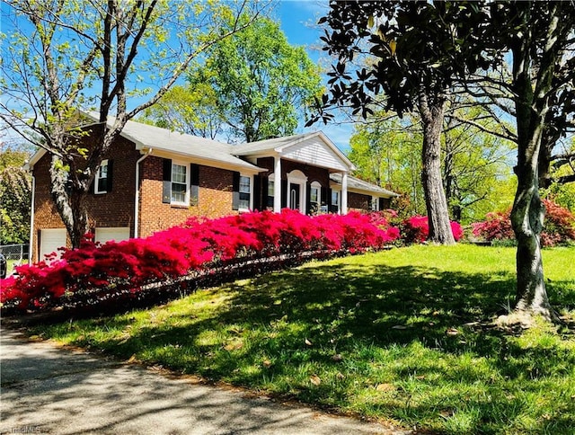 6223 Blue Bonnet Ln, Winston-Salem, NC 27103 - view of front of home with a garage, brick siding, and a front lawn