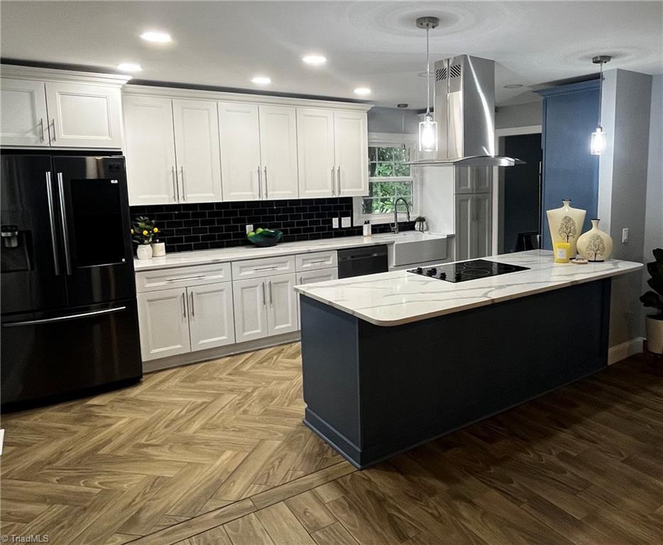 6223 Blue Bonnet Ln, Winston-Salem, NC 27103 - kitchen featuring black appliances, island range hood, a peninsula, white cabinetry, and a sink