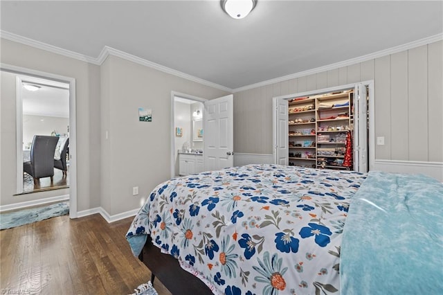 bedroom featuring ensuite bath, baseboards, ornamental molding, and wood finished floors