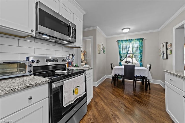 kitchen with dark wood-style floors, backsplash, appliances with stainless steel finishes, ornamental molding, and white cabinets