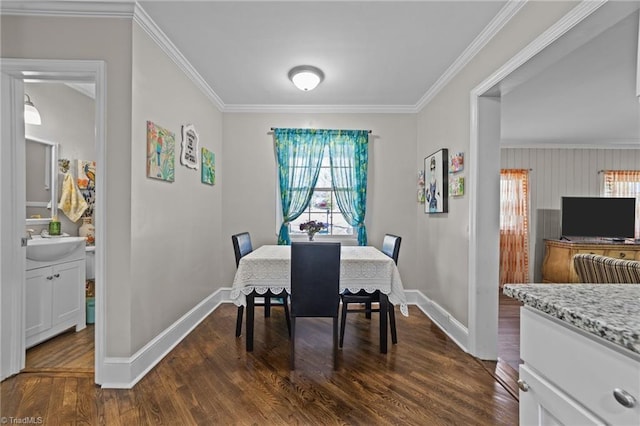 dining space with dark wood-style floors, ornamental molding, and baseboards