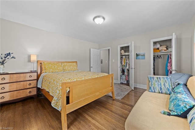 bedroom featuring dark wood-style flooring and baseboards