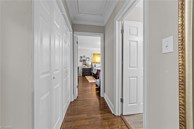 corridor featuring ornamental molding and dark wood-style flooring