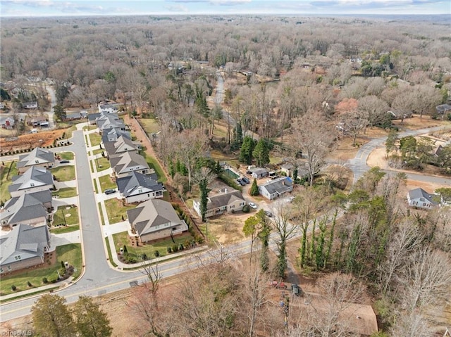 bird's eye view featuring a residential view and a forest view