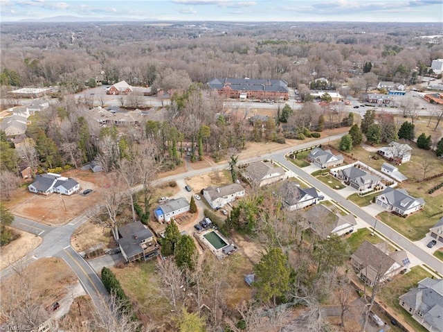 drone / aerial view with a residential view and a wooded view