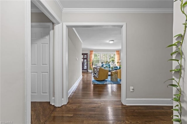 hall featuring ornamental molding, wood finished floors, and baseboards