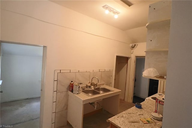 bathroom featuring vaulted ceiling and sink