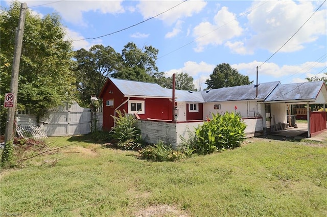 back of house featuring a yard and a wooden deck