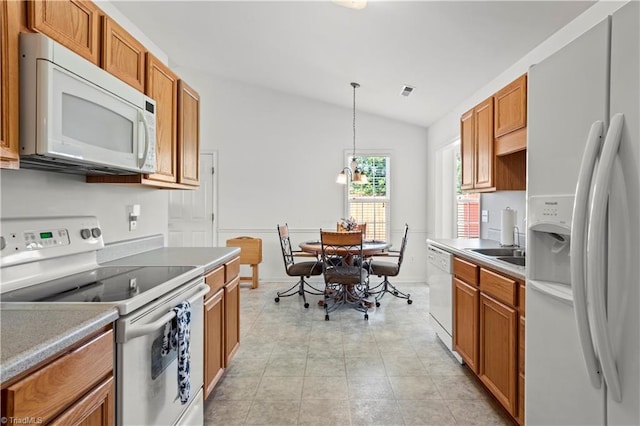 3207 Stavanger Ct, Winston-Salem, NC 27127 - kitchen with white appliances, lofted ceiling, brown cabinets, and pendant lighting