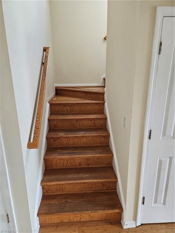 stairs featuring baseboards and wood finished floors