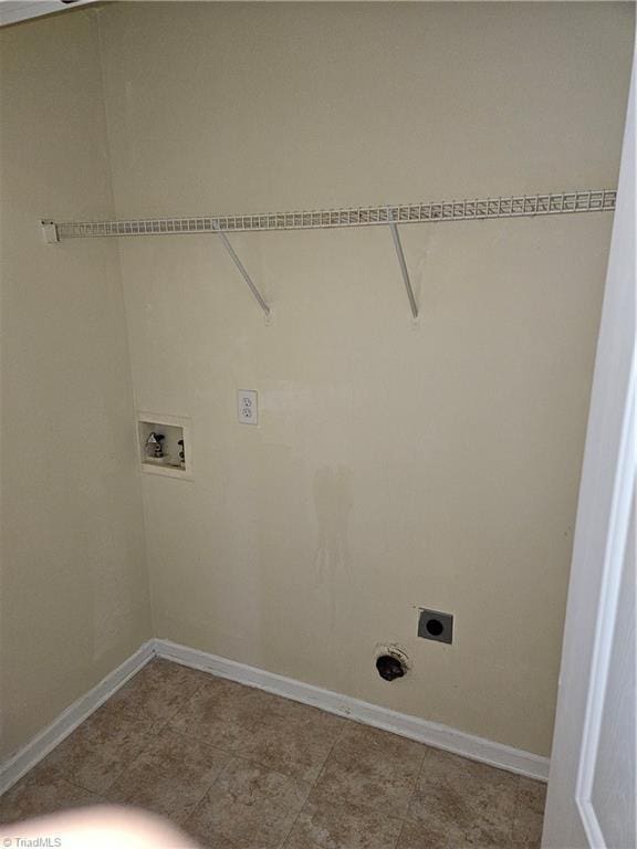 washroom with baseboards, hookup for an electric dryer, and washer hookup