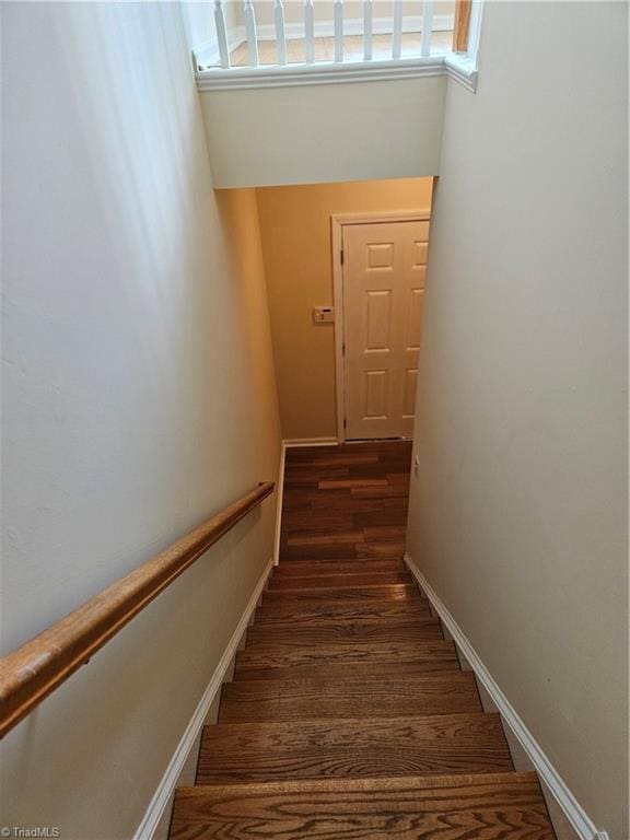 stairs with baseboards and wood finished floors