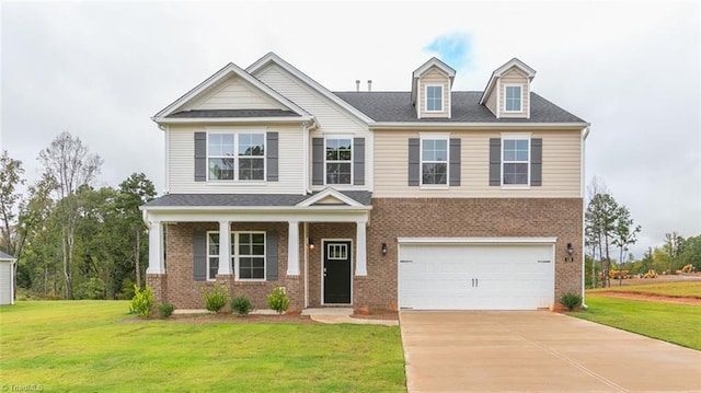 view of front facade featuring a garage, a front lawn, and a porch