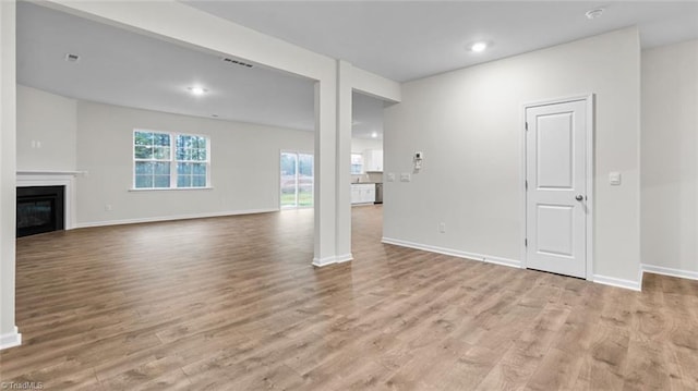 unfurnished living room with light hardwood / wood-style flooring