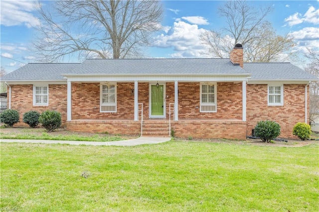 single story home with brick siding, covered porch, a chimney, and a front lawn