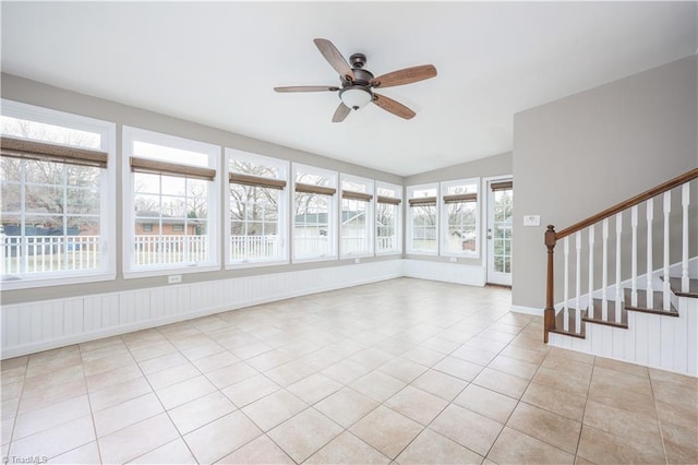 unfurnished sunroom with a ceiling fan