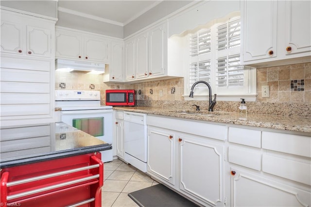 kitchen with under cabinet range hood, white appliances, white cabinetry, and light tile patterned floors