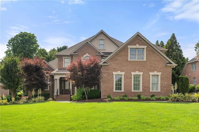 1010 Mill Pointe Way, Elon, NC 27244 - traditional home featuring a front yard and brick siding