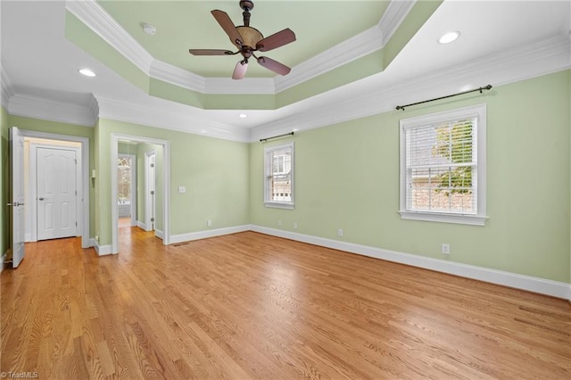 1010 Mill Pointe Way, Elon, NC 27244 - empty room featuring crown molding, ceiling fan, light wood finished floors, and a tray ceiling