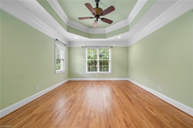 1010 Mill Pointe Way, Elon, NC 27244 - spare room featuring crown molding, a raised ceiling, wood finished floors, and a ceiling fan