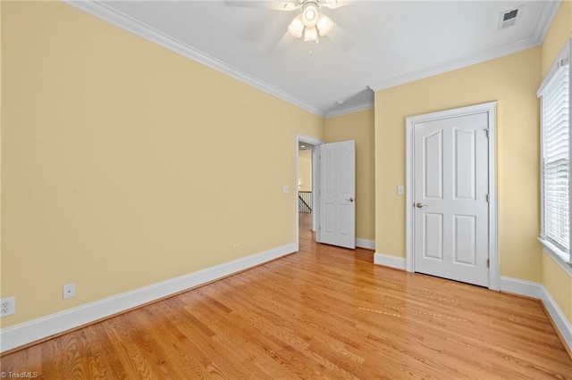 1010 Mill Pointe Way, Elon, NC 27244 - unfurnished bedroom with light wood-style floors, crown molding, multiple windows, and a ceiling fan