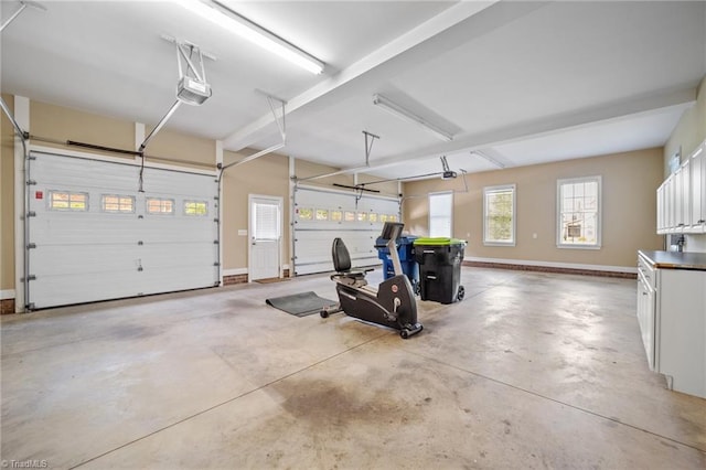 1010 Mill Pointe Way, Elon, NC 27244 - garage with a garage door opener and baseboards