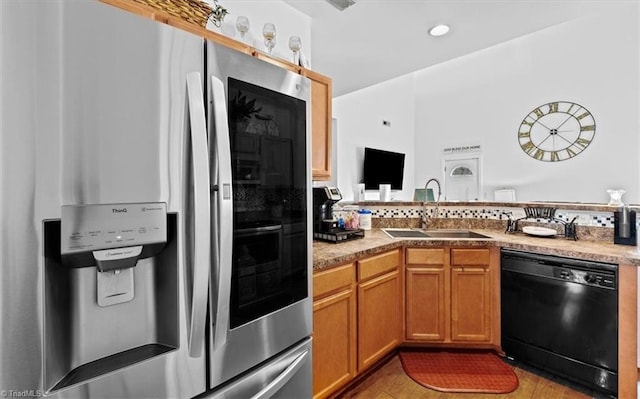 kitchen featuring stainless steel fridge with ice dispenser, black dishwasher, light hardwood / wood-style floors, and sink