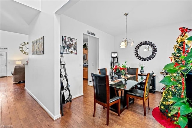 dining area featuring a chandelier and hardwood / wood-style flooring