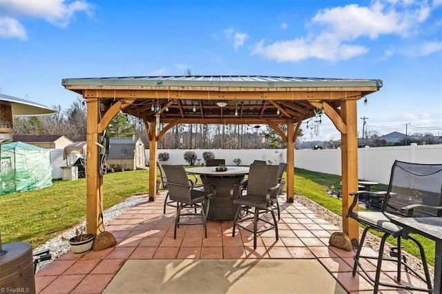 view of patio / terrace featuring a gazebo and a storage shed