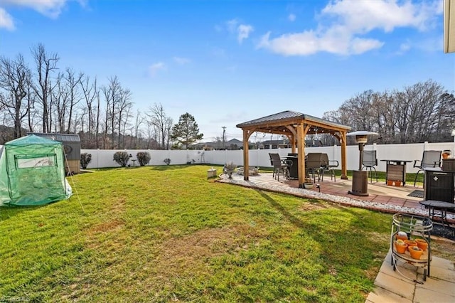 view of yard featuring a gazebo, a shed, and a patio