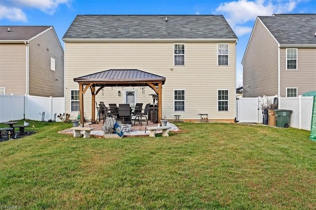 back of property featuring a gazebo, a patio, and a lawn