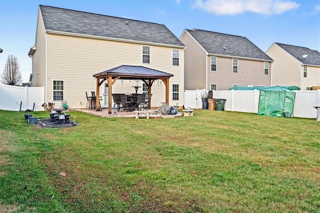 back of house featuring a gazebo and a yard