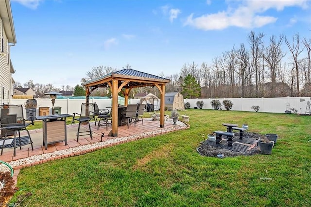 view of yard featuring a gazebo, a patio area, and a storage shed