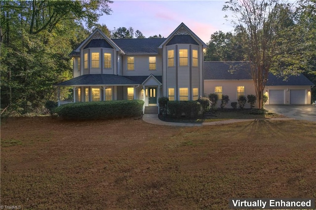 victorian house with a garage and an outdoor structure