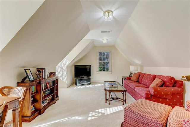 living area featuring visible vents, lofted ceiling, and carpet floors