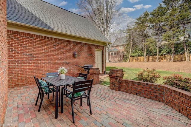 view of patio featuring outdoor dining area and fence