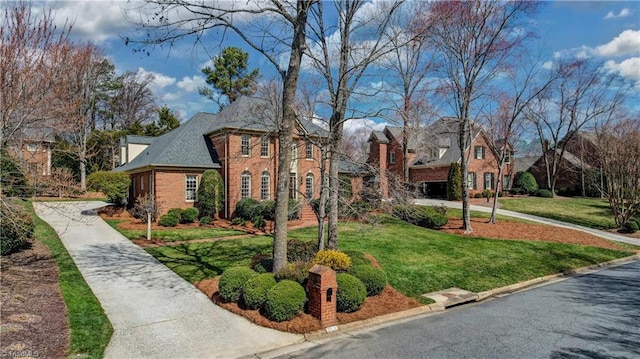 view of front of home with brick siding and a front yard