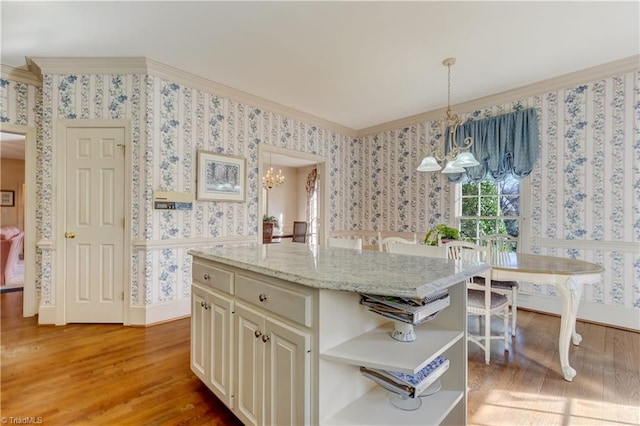 kitchen featuring open shelves, a notable chandelier, ornamental molding, and wallpapered walls