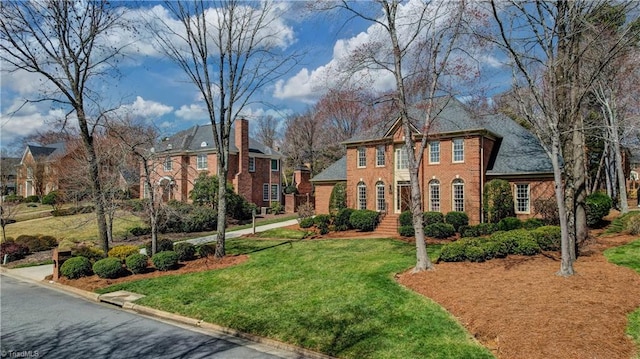 view of front of property featuring brick siding and a front yard